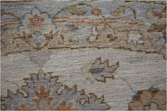 A close-up of a handwoven Afghan Chobi rug featuring traditional floral patterns in earthy tones.