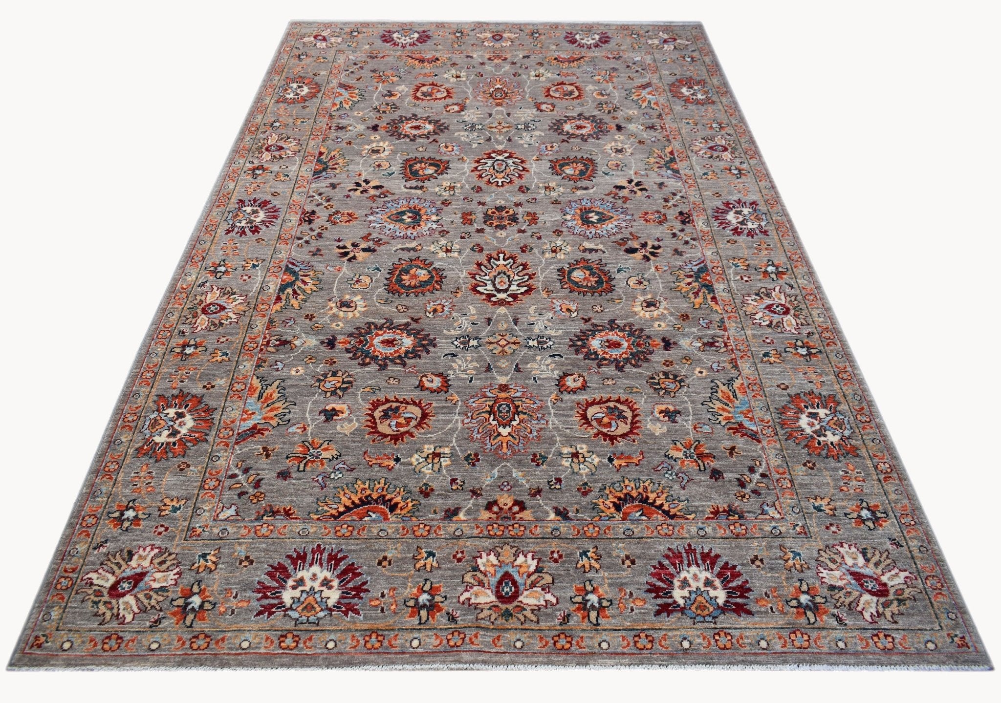 A rectangular Afghan Chobi rug featuring a traditional floral pattern in earthy tones on grey.