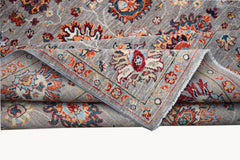 A handwoven Afghan Chobi rug featuring a traditional floral pattern in warm, earthy tones.