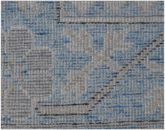 A close-up of a handmade Afghan Chobi rug featuring a textured pattern in blue, grey, and beige.