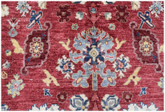 A handmade Afghan Chobi rug featuring a traditional floral pattern in red, blue, and cream tones.