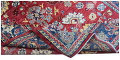 A handmade Afghan Chobi rug featuring a traditional floral pattern in red, blue, and cream tones.