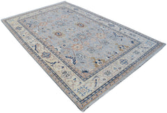 Handmade Afghan Chobi rug featuring a traditional floral pattern in soft blue and beige tones.