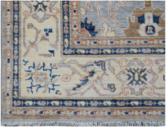 A handmade Afghan Chobi rug featuring a traditional floral pattern in blue, beige, and tan tones.