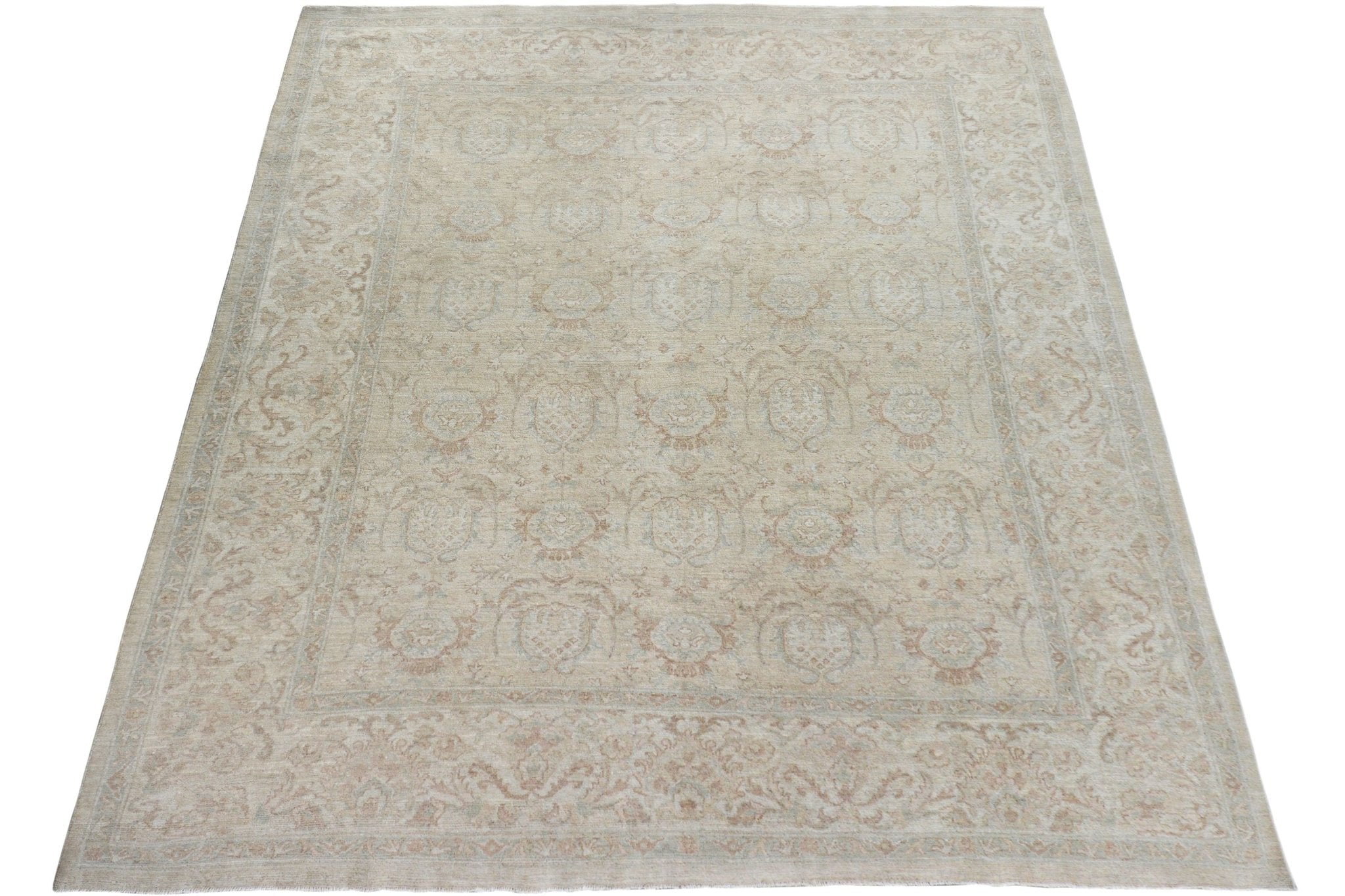 A handmade Afghan Chobi rug featuring a traditional floral pattern in soft beige and wood tones.