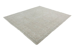 A handmade Afghan Chobi rug featuring a traditional floral pattern in neutral beige tones.