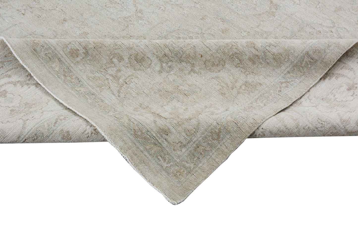 A handmade Afghan Chobi rug featuring a traditional floral pattern in neutral beige tones.