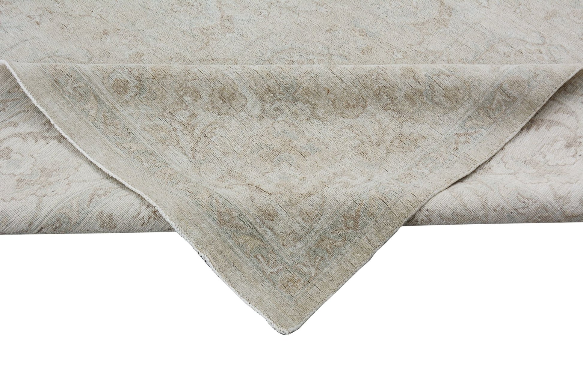 A handmade Afghan Chobi rug featuring a traditional floral pattern in neutral beige tones.