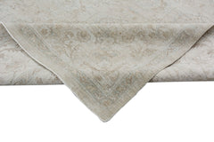 A handmade Afghan Chobi rug featuring a traditional floral pattern in neutral beige tones.