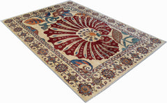 A handmade Afghan Chobi rug featuring a large central floral motif on a cream background.