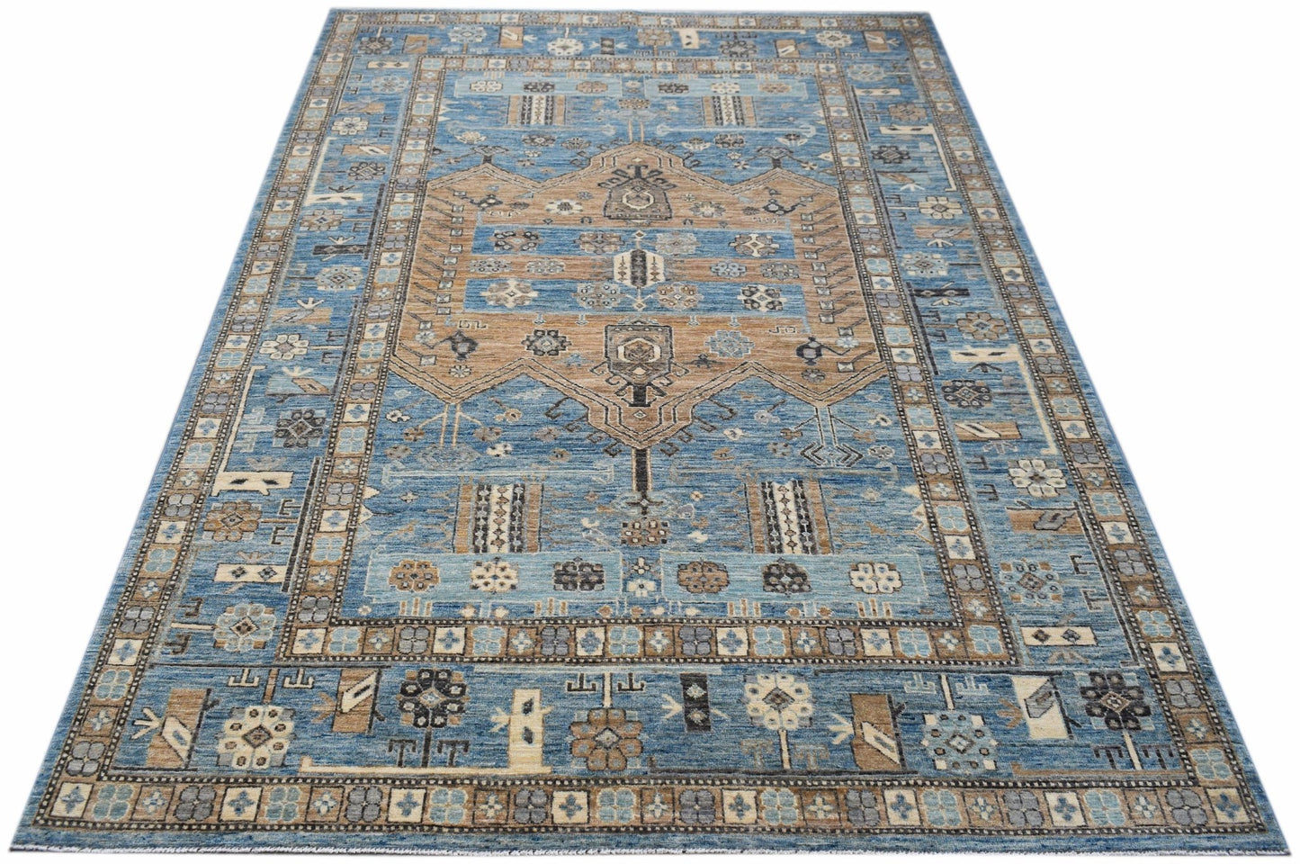 Handwoven Afghan Chobi rug featuring a traditional geometric pattern in blue and tan tones.