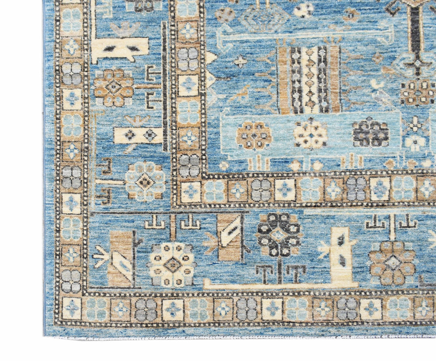A handmade Afghan Chobi rug featuring intricate geometric patterns in shades of blue and tan.