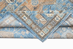 A handwoven Afghan Chobi rug featuring traditional geometric patterns in blue and tan tones.