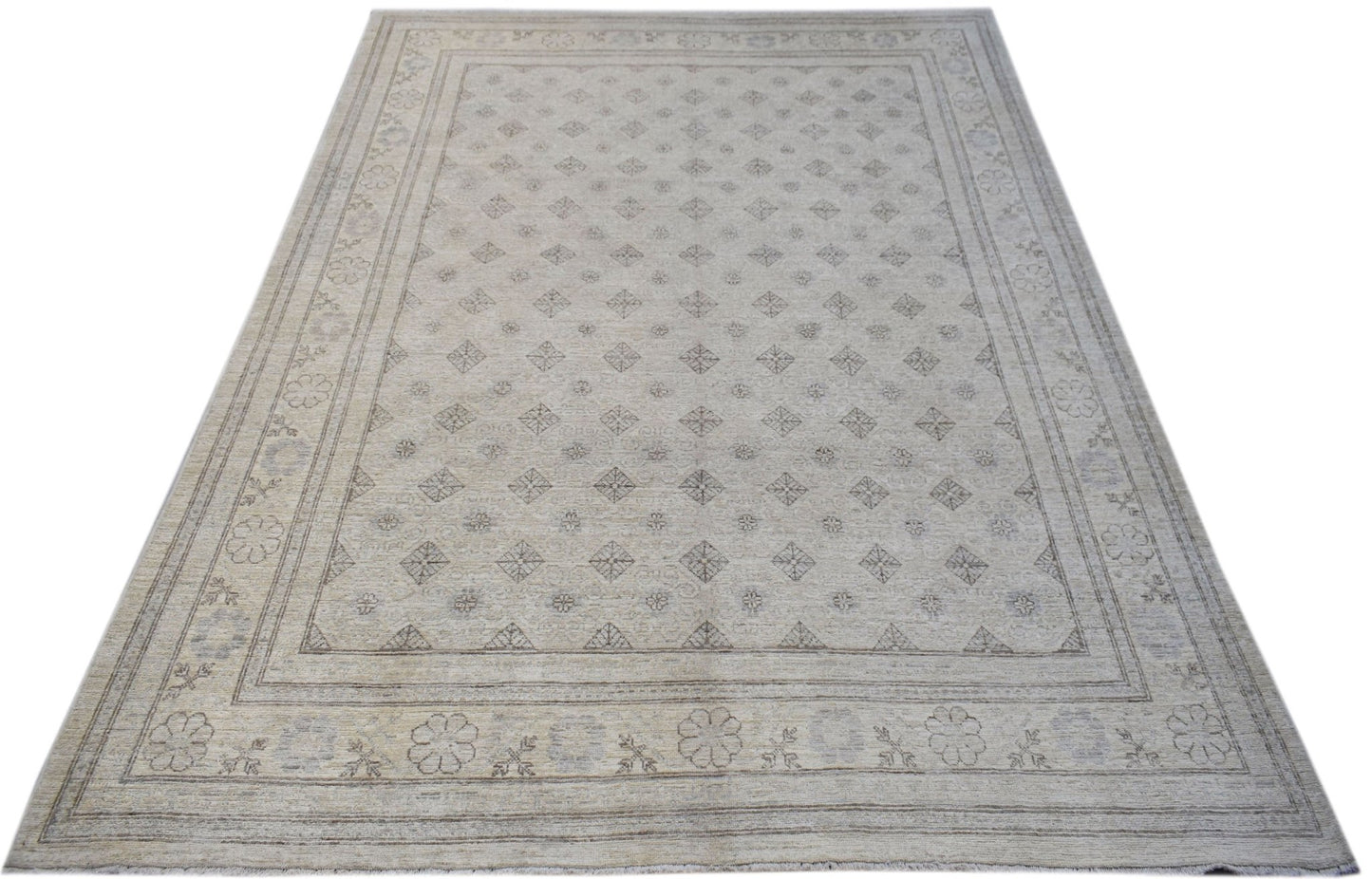 A rectangular Afghan Chobi rug featuring a light beige field with a repeating diamond pattern.