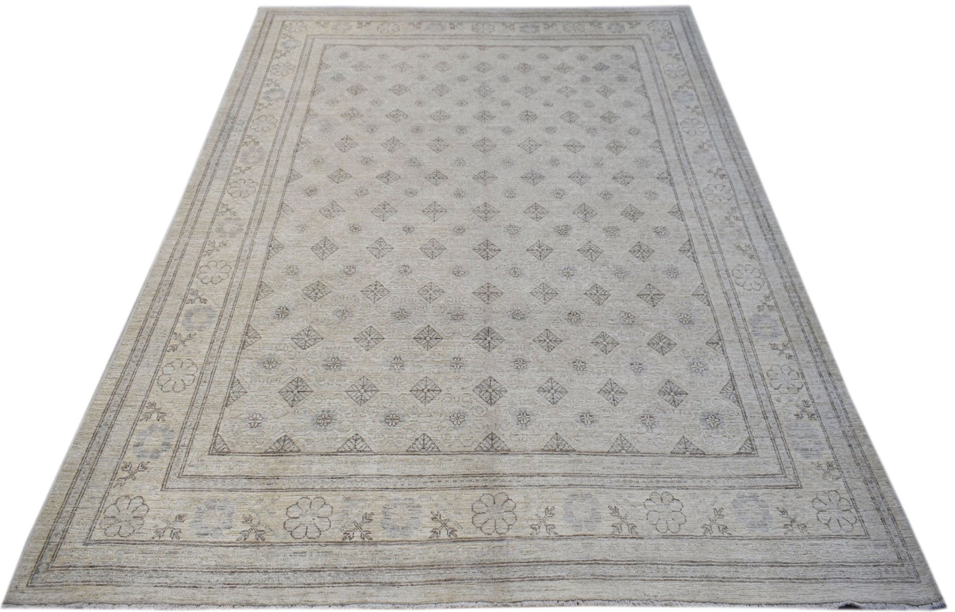 A rectangular Afghan Chobi rug featuring a light beige field with a repeating diamond pattern.