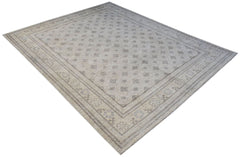 A handwoven Afghan Chobi rug featuring a light beige field with a repeating geometric floral motif.