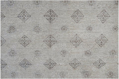An Afghan Chobi rug featuring a repeating pattern of diamonds and floral motifs in neutral tones.