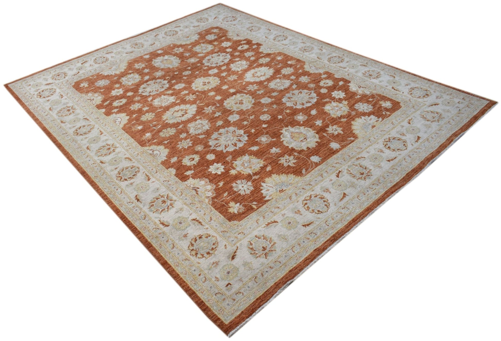 A rectangular Afghan Chobi rug featuring a floral pattern in rust orange and cream tones.