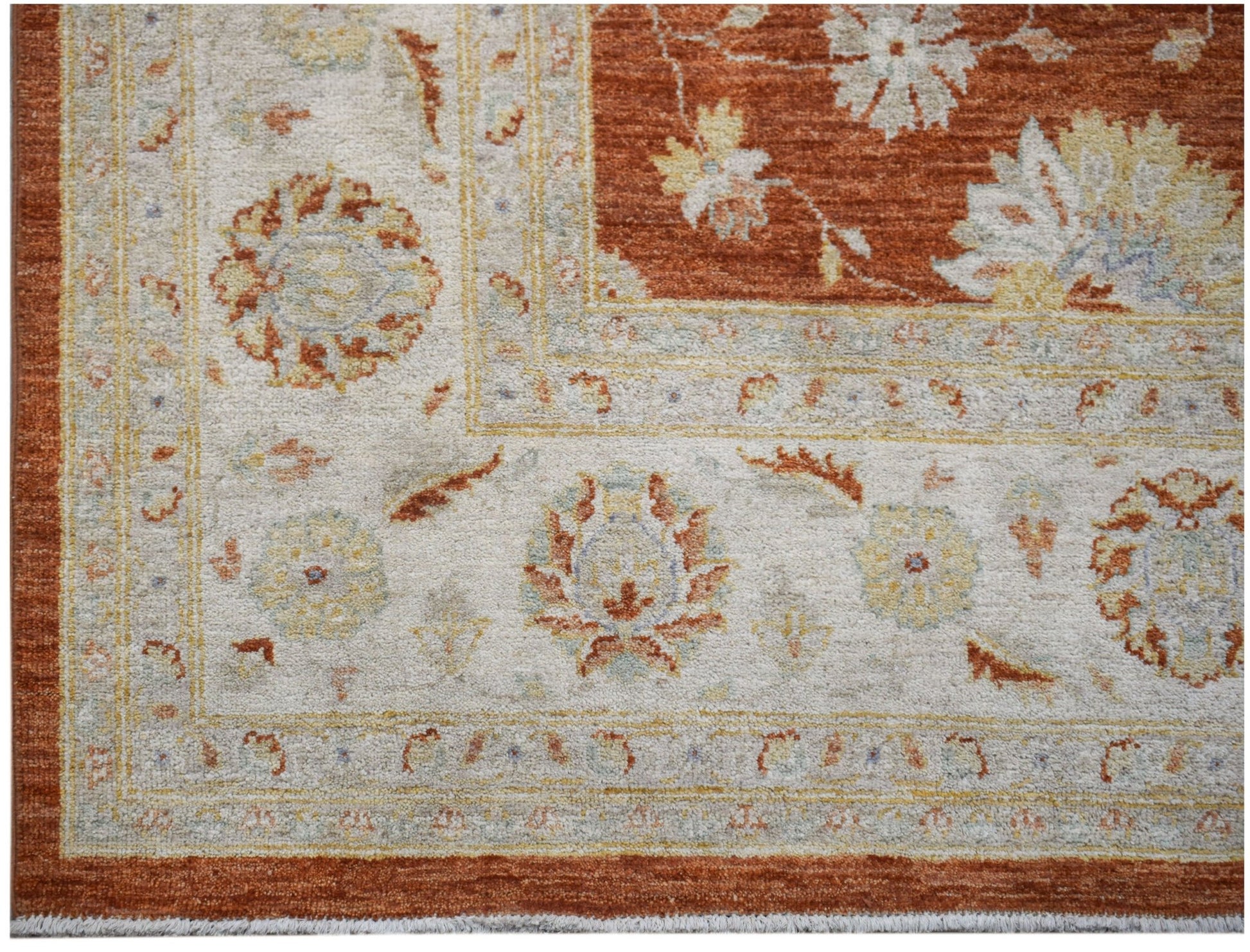 A handmade Afghan Chobi rug featuring a traditional floral pattern in rust and cream tones.