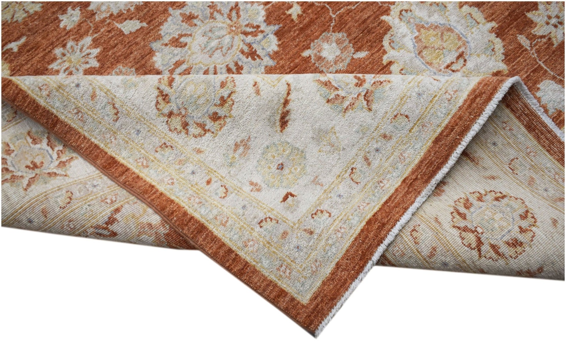 A handmade Afghan Chobi rug featuring a traditional floral pattern in rust and cream tones.