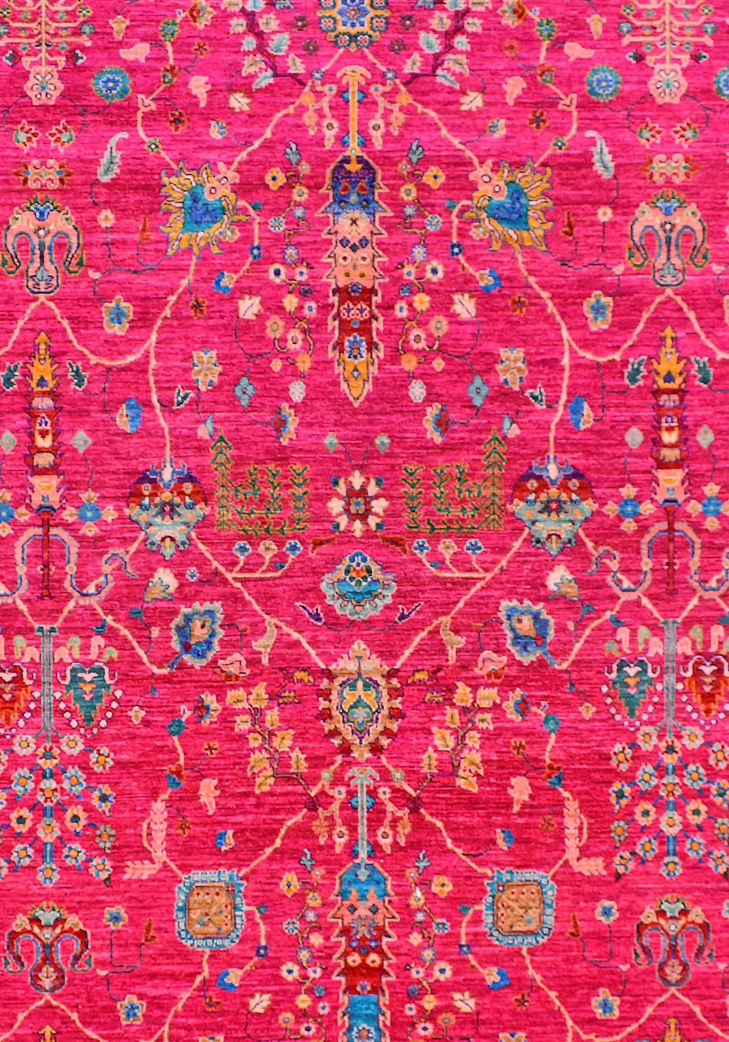 A handwoven Afghan Chobi rug featuring intricate floral patterns in vibrant pink and blue tones.