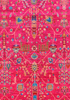 A handwoven Afghan Chobi rug featuring intricate floral patterns in vibrant pink and blue tones.