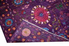 A handwoven Afghan Chobi rug featuring a vibrant purple field with floral and pomegranate motifs.