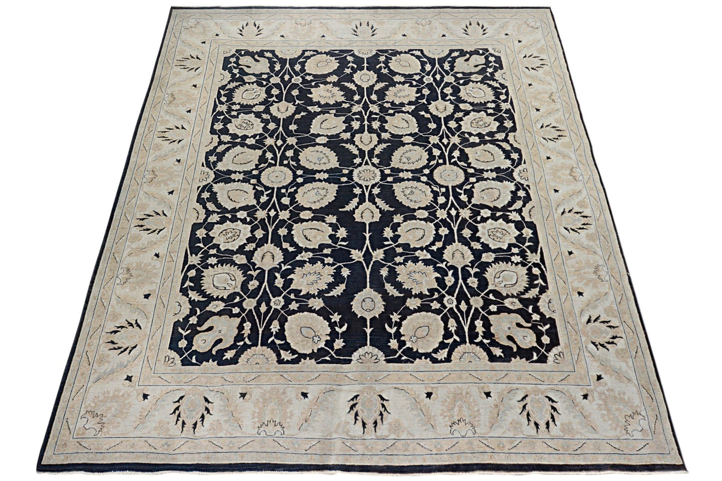 Handmade Afghan Chobi rug featuring a dark field with intricate floral patterns and a beige border.