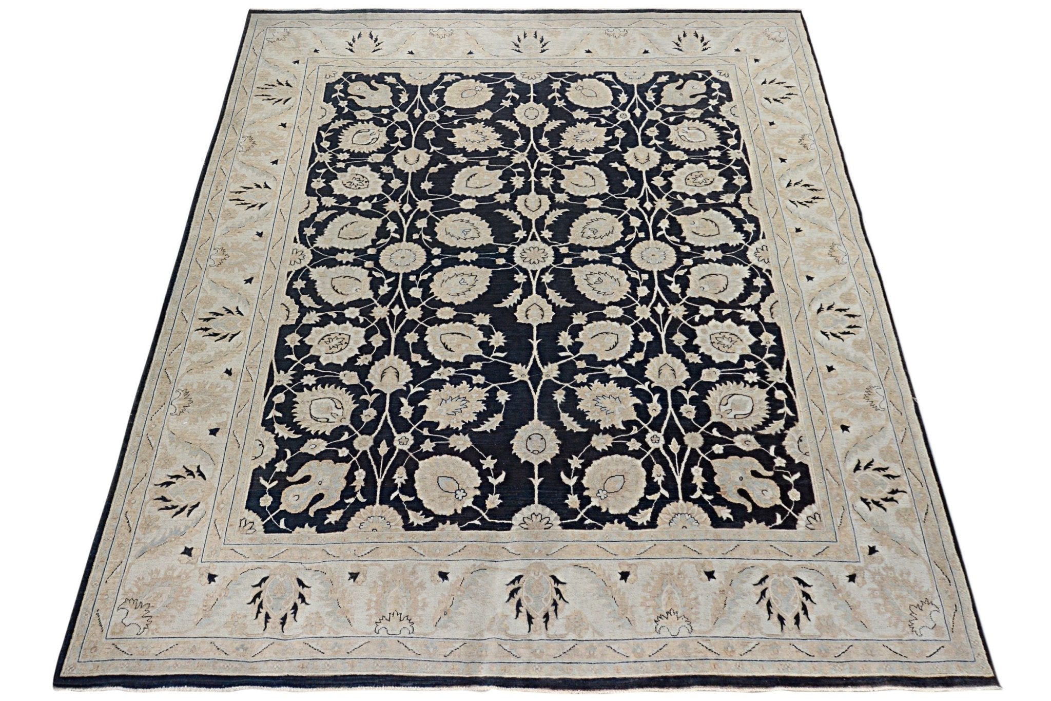 Handmade Afghan Chobi rug featuring a dark field with intricate floral patterns and a beige border.