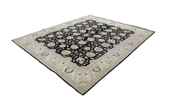 A handmade Afghan Chobi rug featuring a black floral field with a beige decorative border.