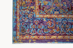 A handwoven Afghan Chobi rug featuring intricate floral patterns in blue, purple, and gold tones.