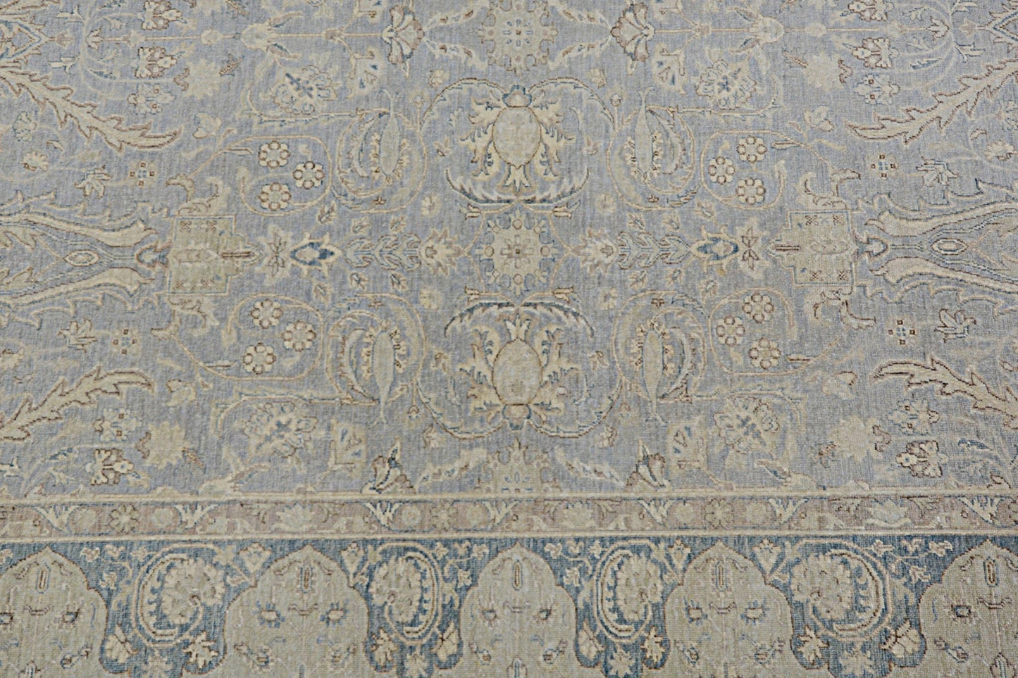 Handmade Afghan Chobi rug featuring a traditional floral pattern in soft blue and beige tones.