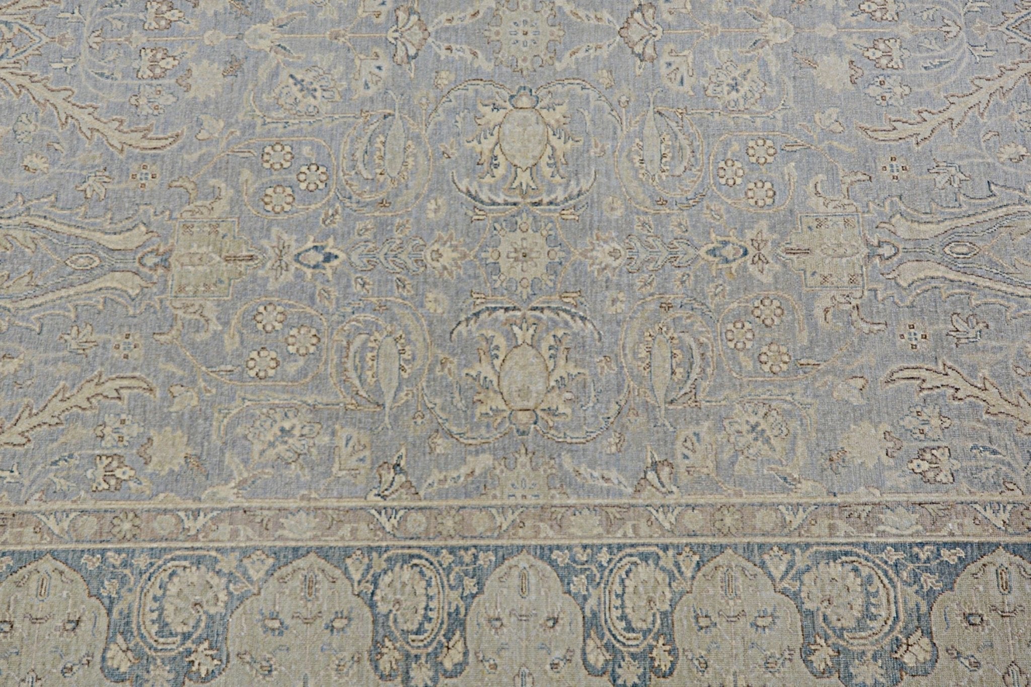 Handmade Afghan Chobi rug featuring a traditional floral pattern in soft blue and beige tones.