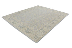 A handmade Afghan Chobi rug featuring a traditional floral pattern in soft blue and beige tones.