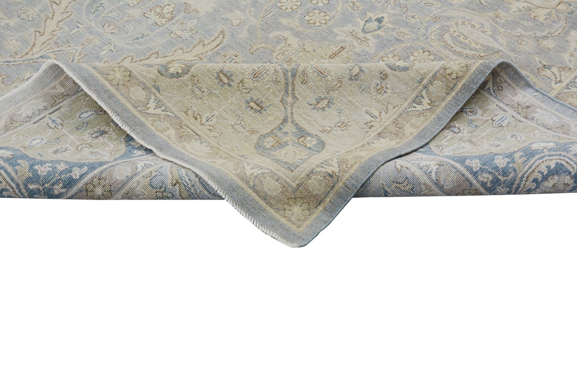 A handmade Afghan Chobi rug featuring a traditional floral pattern in soft blue and beige tones.