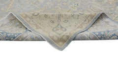 A handmade Afghan Chobi rug featuring a traditional floral pattern in soft blue and beige tones.