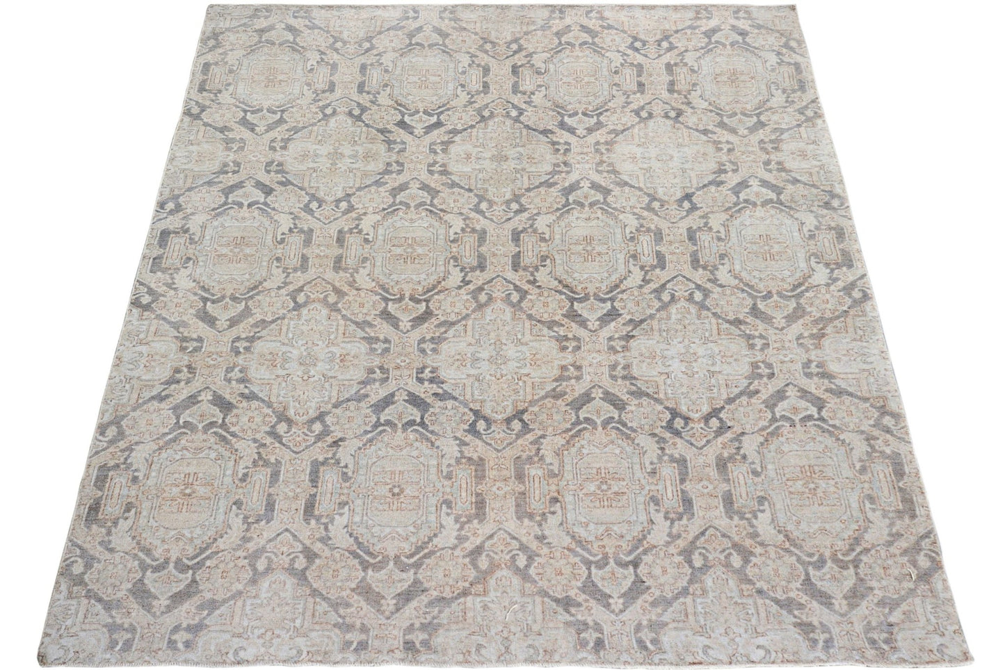 A handmade Afghan Chobi rug featuring a traditional geometric pattern in muted earth tones.