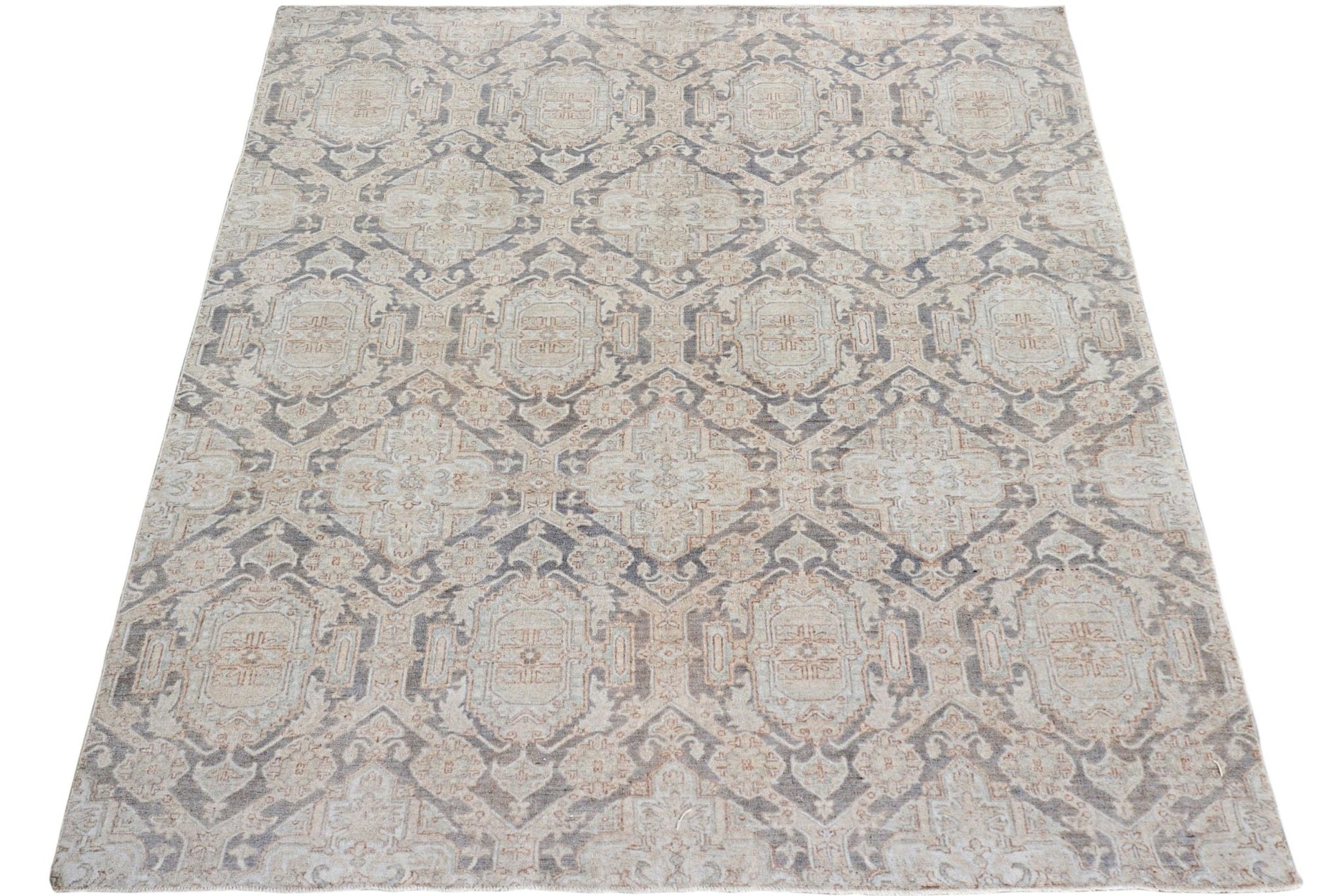 A handmade Afghan Chobi rug featuring a traditional geometric pattern in muted earth tones.