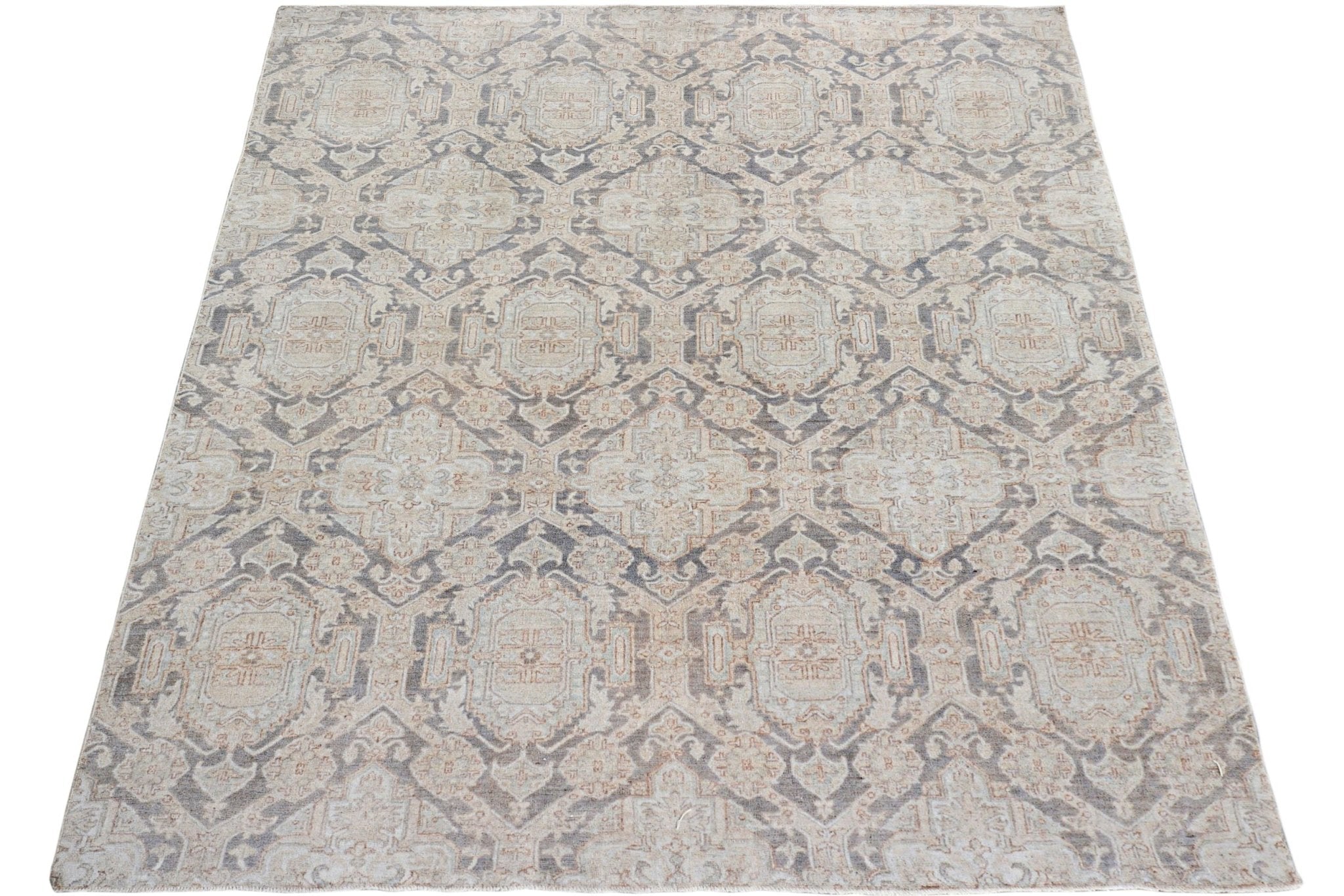 A handmade Afghan Chobi rug featuring a traditional geometric pattern in muted earth tones.