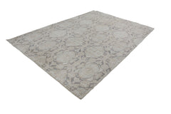An Afghan Chobi rug featuring a traditional geometric pattern in neutral beige and grey tones.