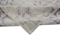 A handmade Afghan Chobi rug featuring a traditional pattern in muted grey, beige, and blue tones.