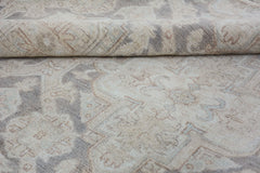 A handmade Afghan Chobi rug featuring a traditional pattern in neutral beige and grey tones.