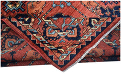 A handmade Afghan Chobi rug featuring traditional geometric patterns in red, blue, and cream.