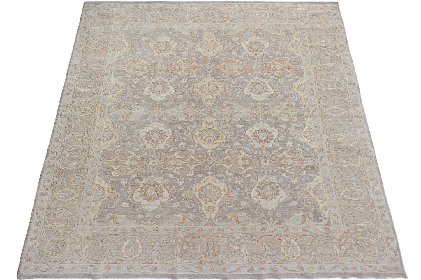 A handmade Afghan Chobi rug featuring a traditional floral pattern in soft beige and grey tones.