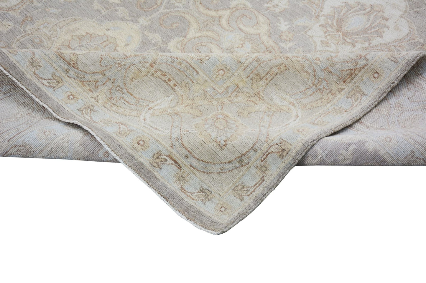 A handmade Afghan Chobi rug featuring a traditional floral pattern in soft beige and brown tones.