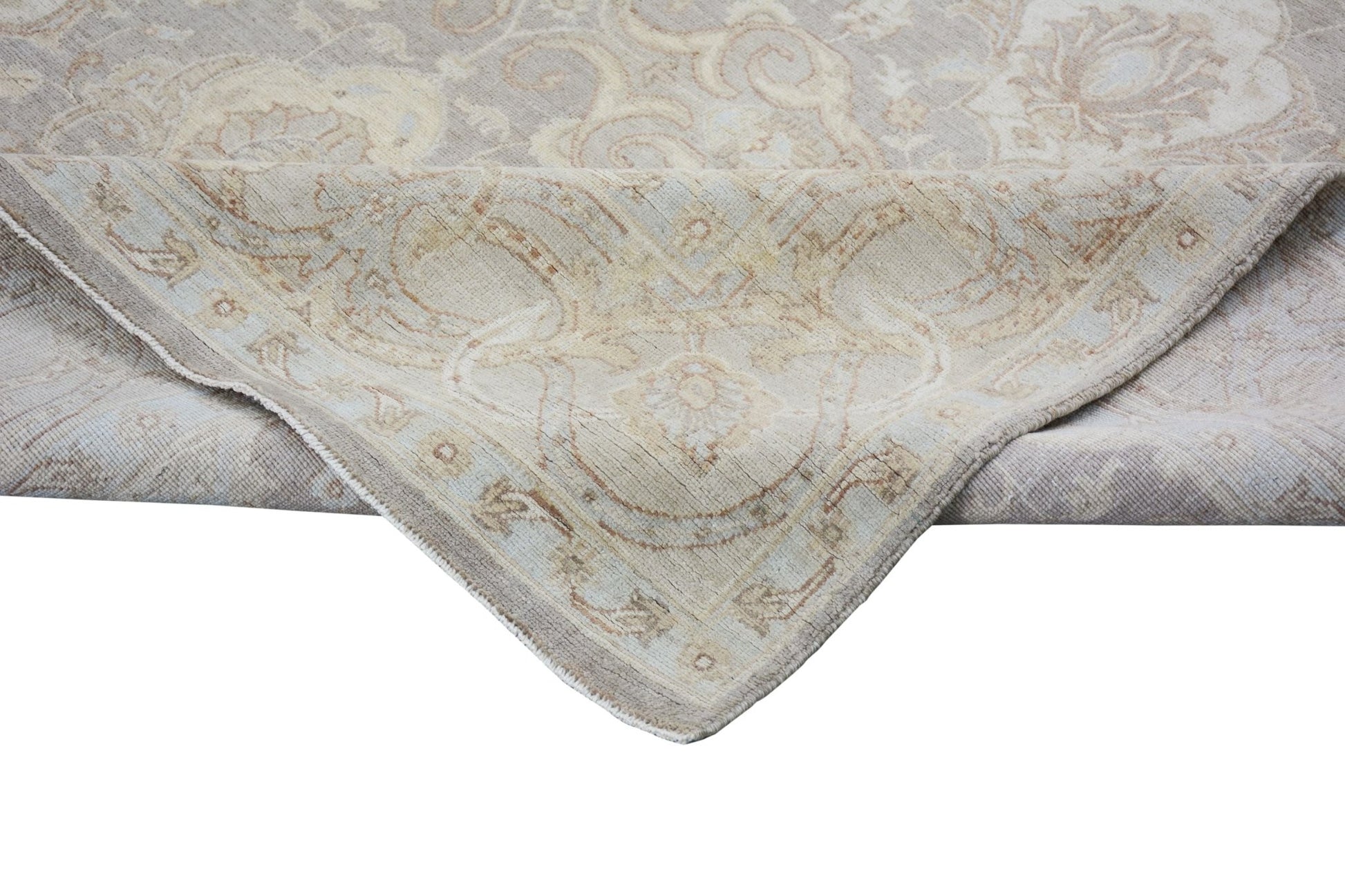A handmade Afghan Chobi rug featuring a traditional floral pattern in soft beige and brown tones.