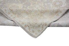 A handmade Afghan Chobi rug featuring a traditional floral pattern in soft beige and brown tones.