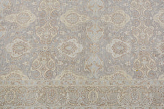 A handmade Afghan Chobi rug featuring a traditional floral pattern in soft beige and grey tones.
