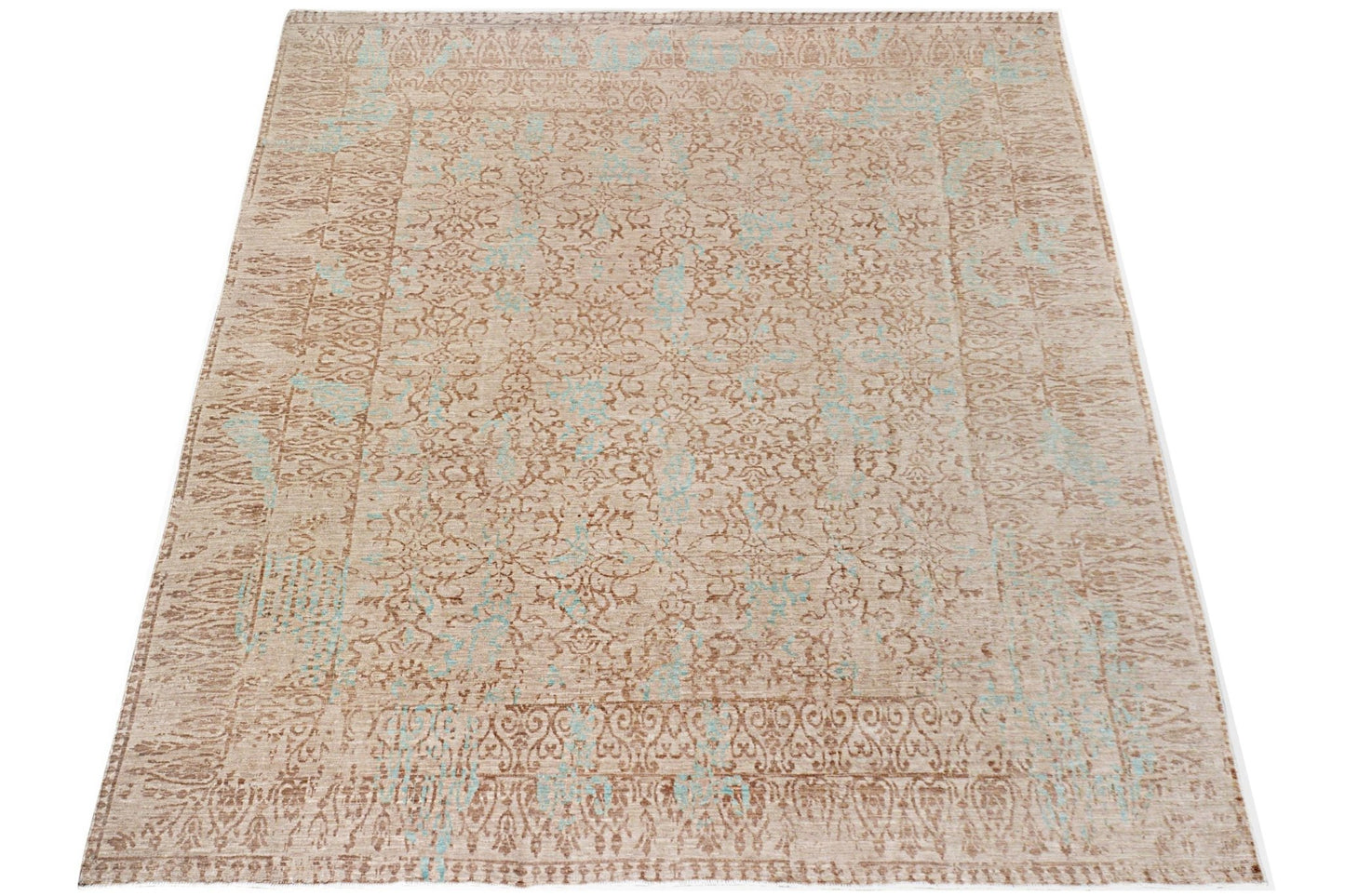 A handmade Afghan Chobi rug featuring a traditional floral pattern in beige and light blue tones.