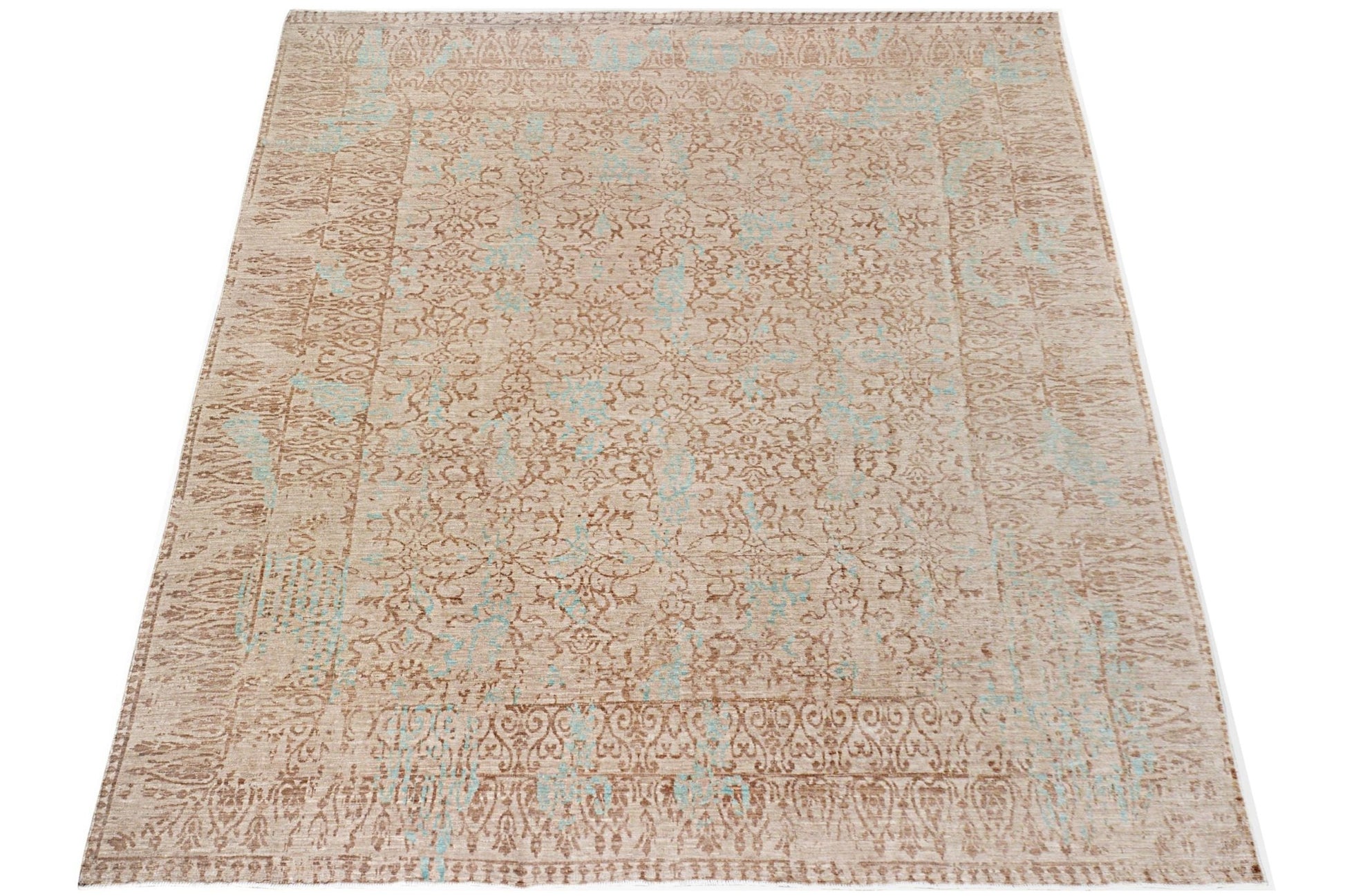 A handmade Afghan Chobi rug featuring a traditional floral pattern in beige and light blue tones.